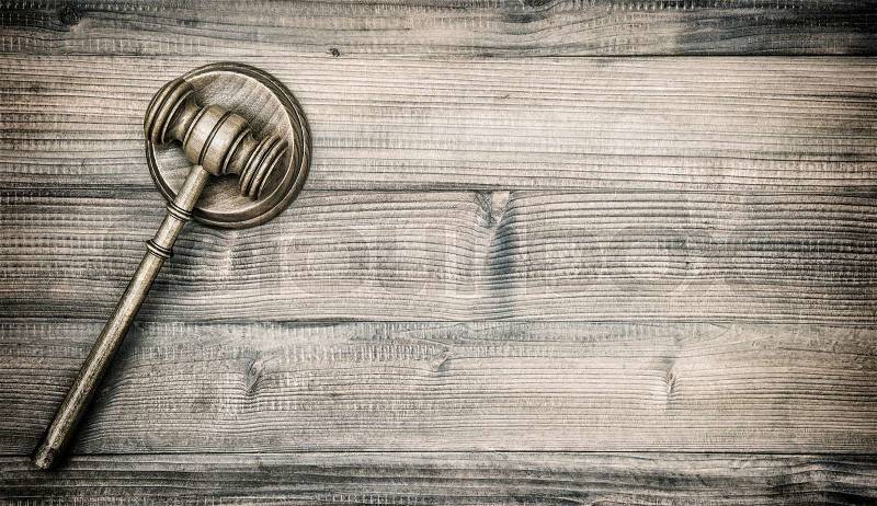 Judges Gavel with Soundboard. Auctioneer hammer on wooden background. VIntage style toned picture, stock photo