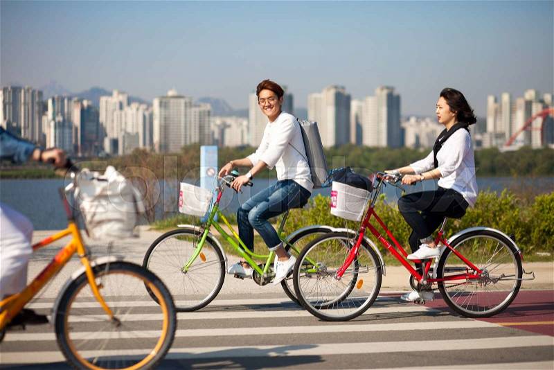 SEOUL, KOREA - APRIL 24, 2015: People cycling at a racreation park zone on the bank of Hangang river in Seoul, Korea, stock photo