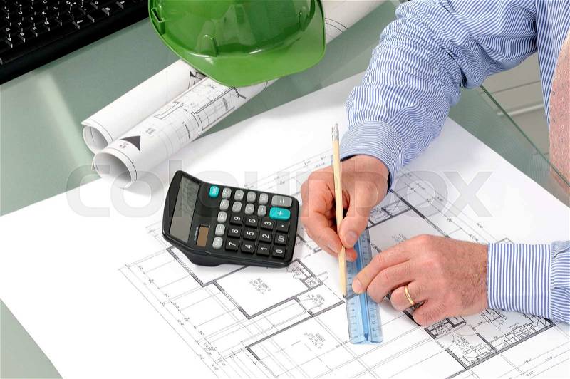 Engineer at work in the office on a residential construction project, stock photo