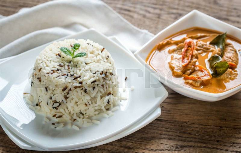 Thai panang curry with bowl of white and wild rice, stock photo