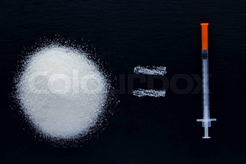 Handful of sugar and insulin syringe on a black background, stock photo
