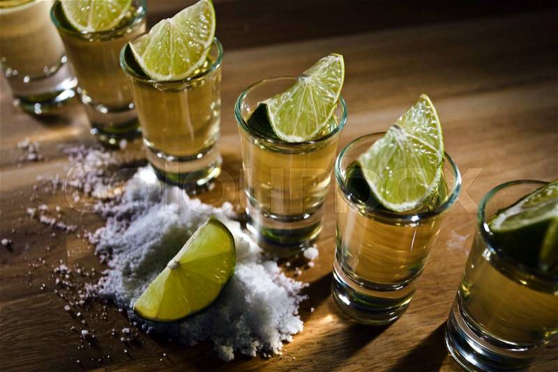 Tequila , lime and salt on wooden table, stock photo