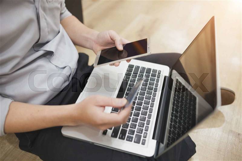 Man is holding a credit card and using pc or laptop for online shopping , stock photo
