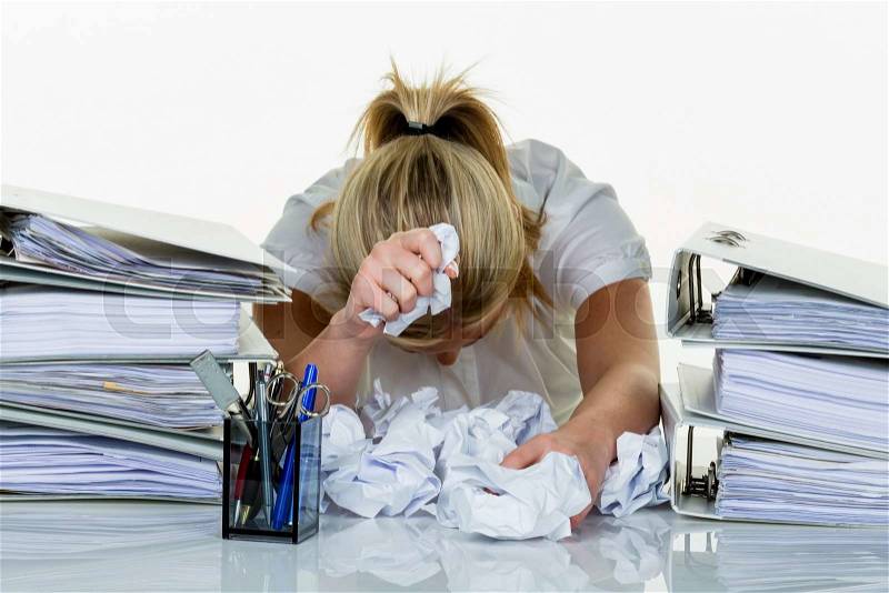 Young woman in office is overwhelmed with work. burnout at work or study, stock photo