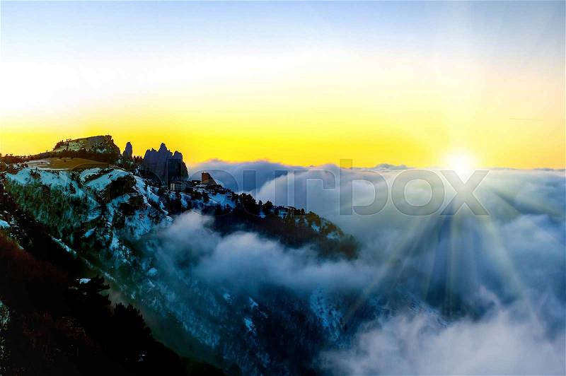 Sunset in mountains with clouds over sunset sky, stock photo