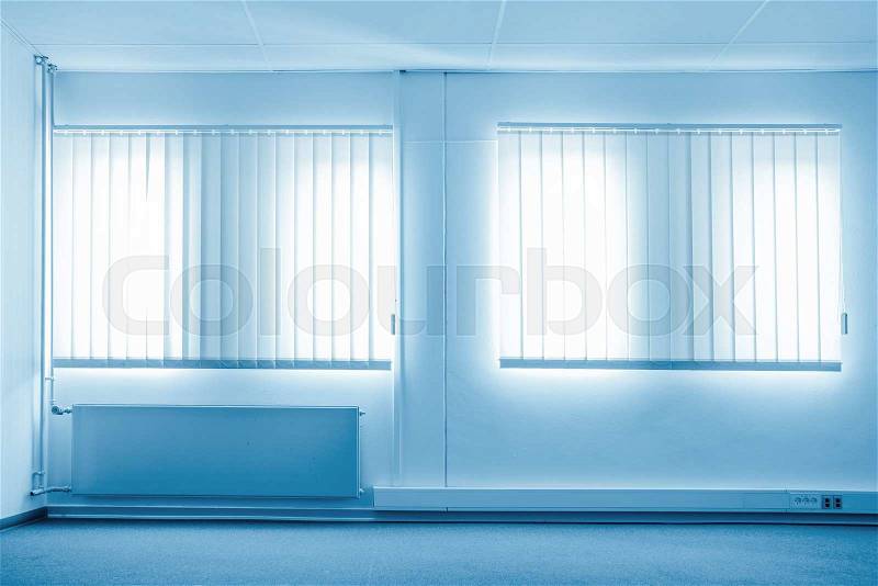 Sunshine coming through windows in a blue room, stock photo