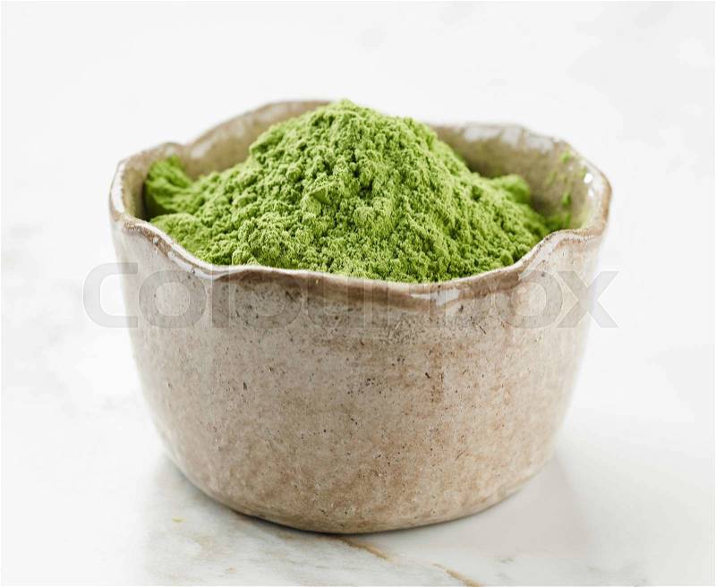 Bowl of green wheat grass powder, stock photo