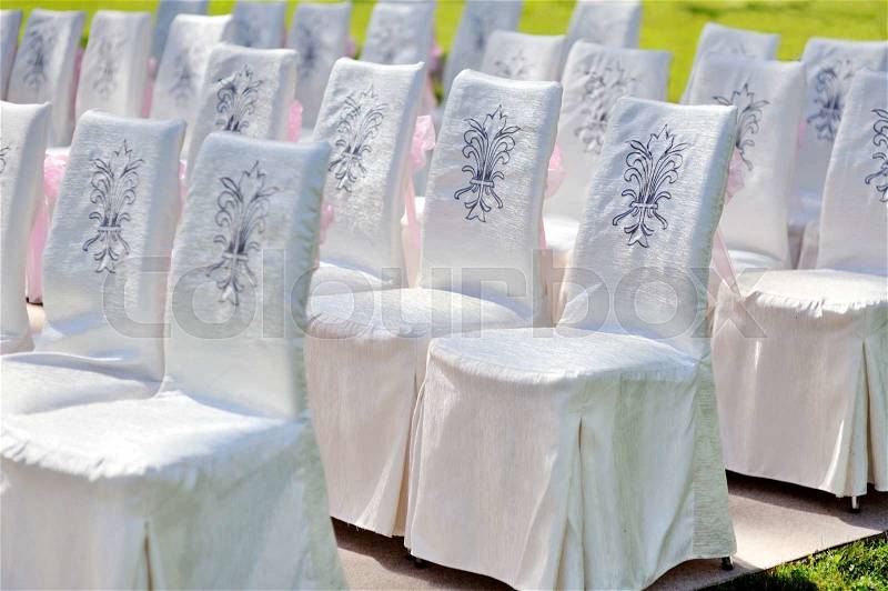 White Wedding chairs for ceremony in summer park, stock photo