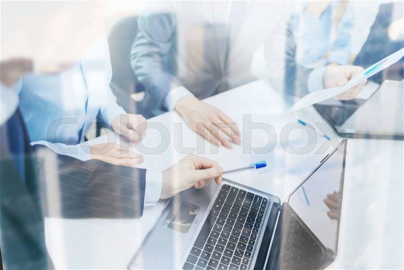 Business and office concept - close up of business team with files and laptop computer in office, stock photo