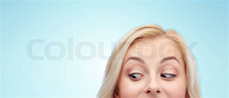 Curiosity, advertisement and people concept - happy young woman or teenage girl face over blue background, stock photo