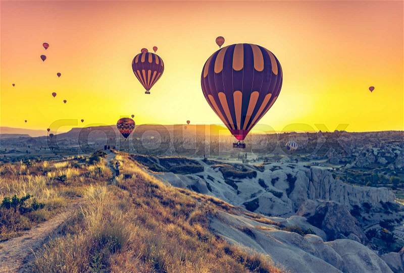 Hot air balloons flying over spectacular Cappadocia, stock photo