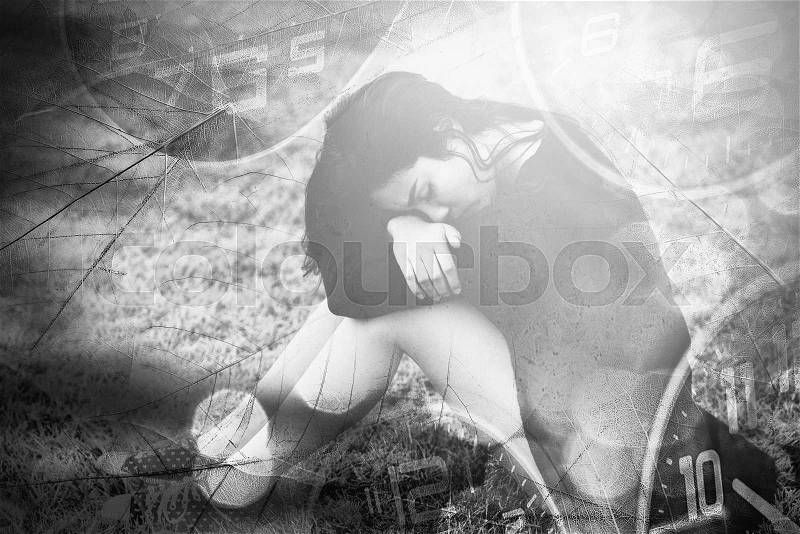 Sad woman sitting on floor with blur clock around. Feeling blue or painful concept, stock photo