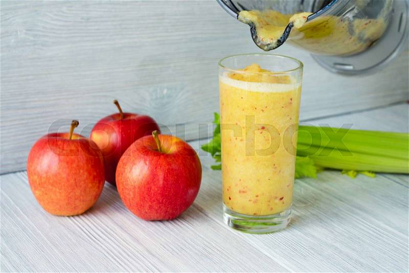 Full glass of smoothie made from apples and celery poured out of the food processor. Concept diet food, stock photo