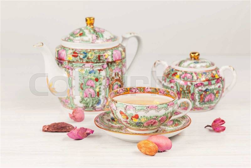 The tea and tea porcelain set on the white wooden table , stock photo
