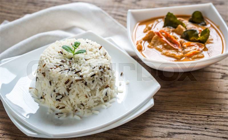 Thai panang curry with bowl of white and wild rice, stock photo