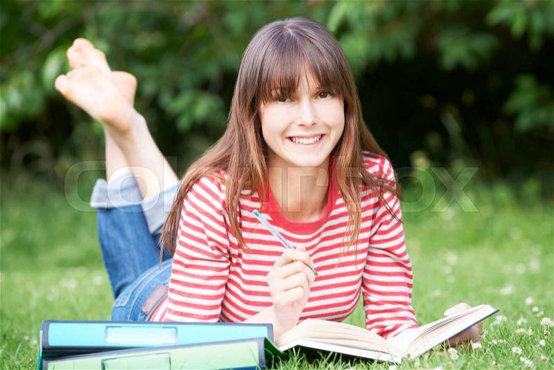 Young Female Student Studying In Park, stock photo