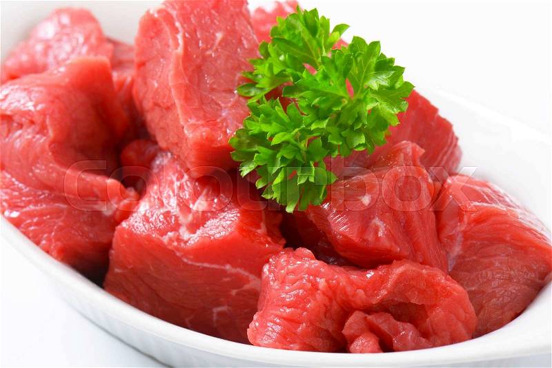 Raw diced beef in a porcelain bowl, stock photo