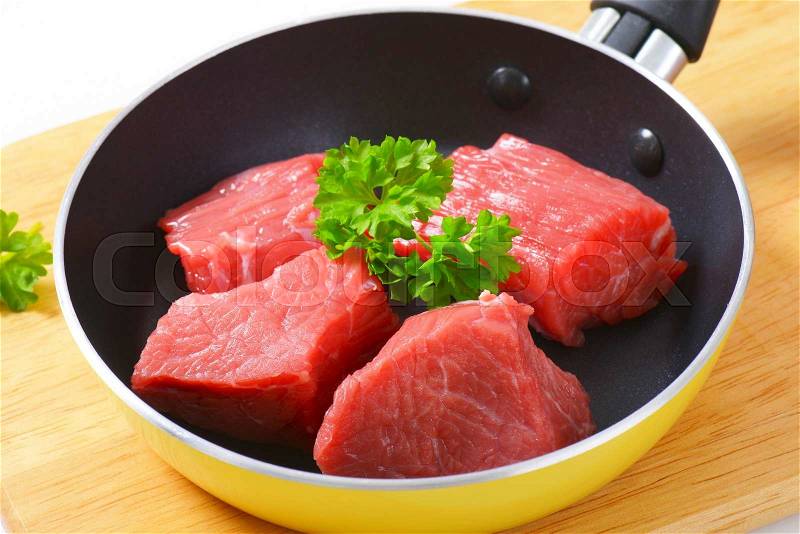 Raw diced beef in a pan, stock photo