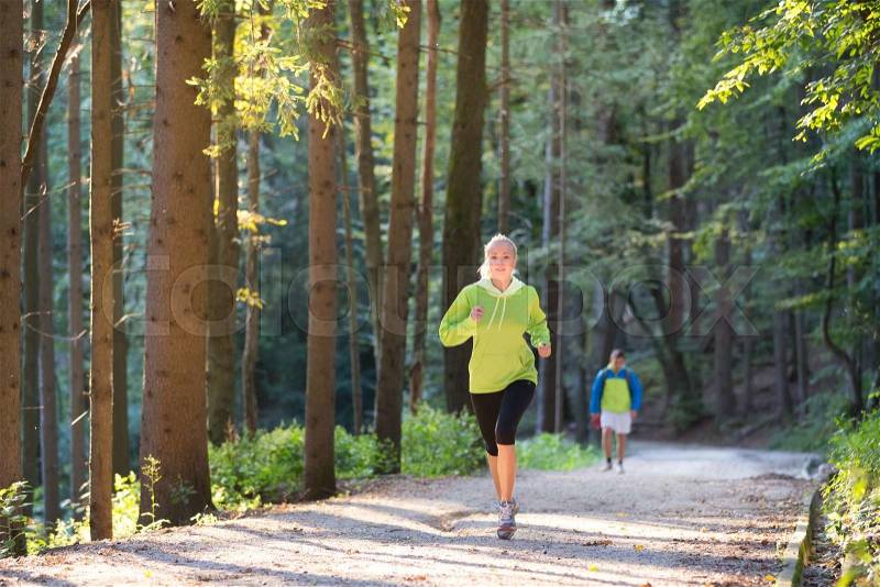 Pretty young girl runner in the forest. Running woman. Female Runner Jogging during Outdoor Workout in a Nature. Beautiful fit Girl. Fitness model outdoors. Weight Loss. Healthy lifestyle. , stock photo