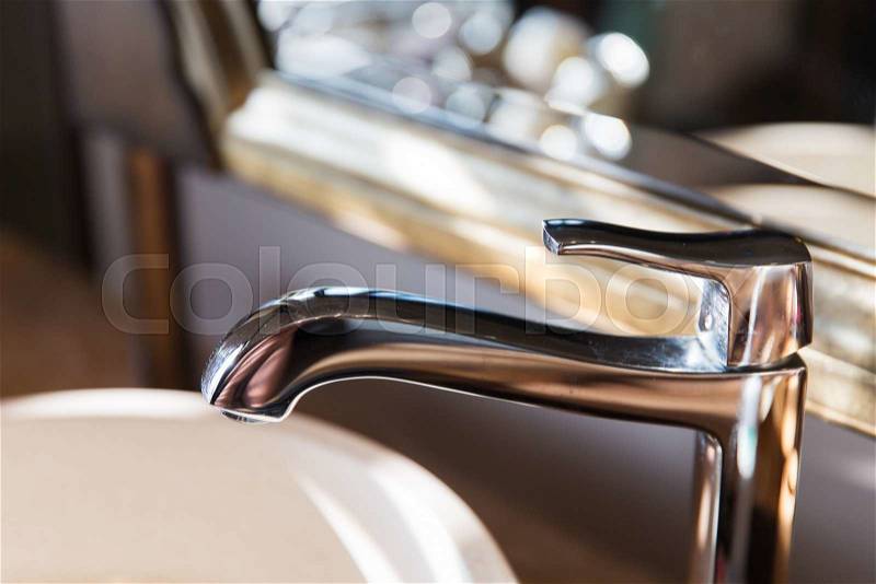 Sanitary, plumbing and washing concept - close up of bath tap or faucet at bathroom, stock photo