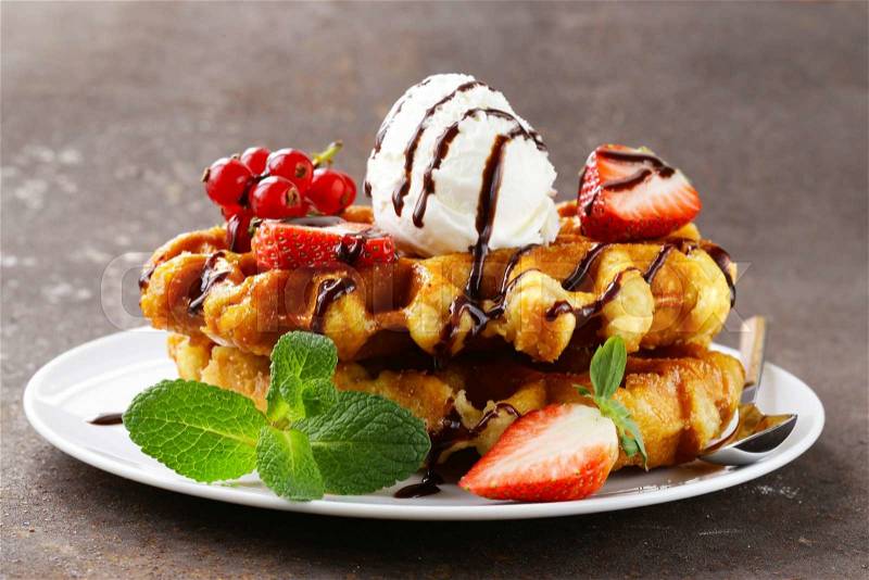 Belgian waffles with berries (currants, strawberries) and ice cream, stock photo