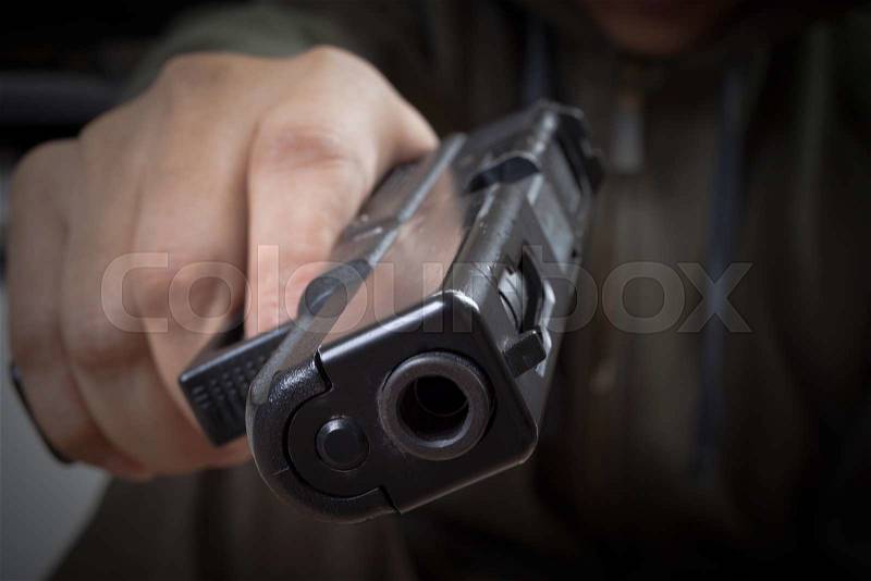 Gun in hand and pointing with killer, safety and criminal concept background, stock photo