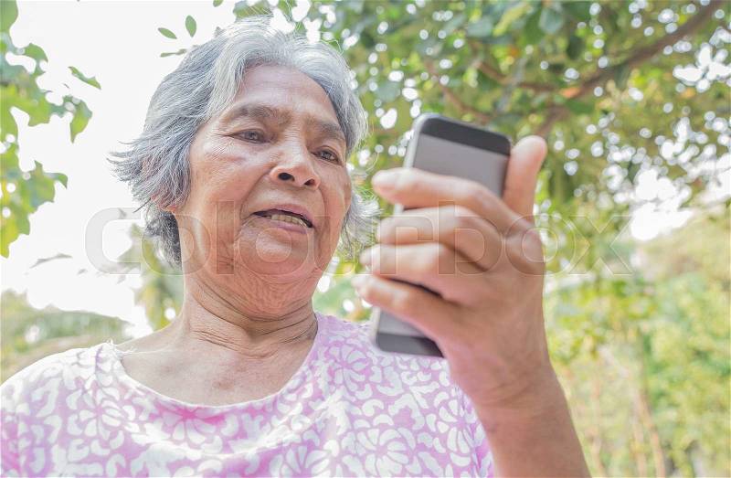 Woman elderly Using a Smart Phone, stock photo