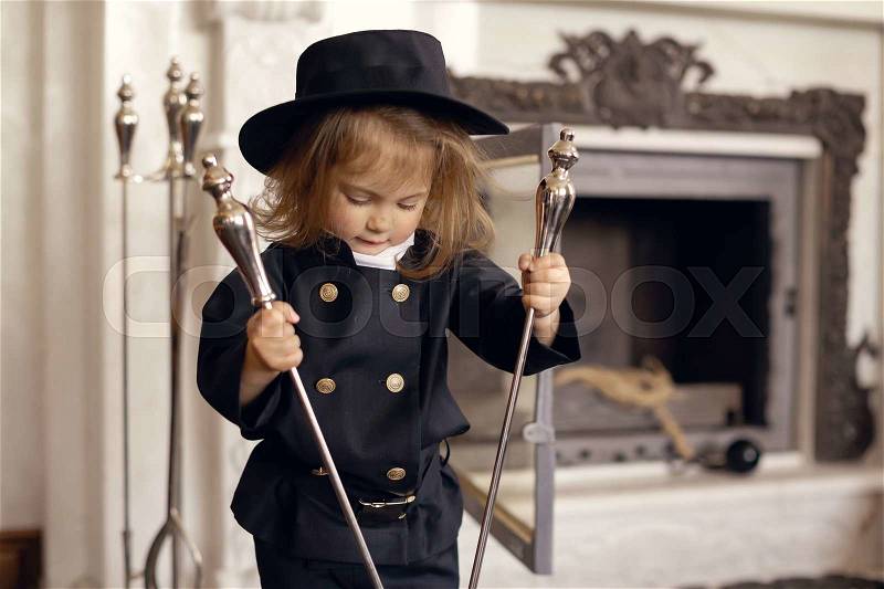 Girl as a chimney sweep against fireplace. Lucky New Year\'s Eve and New Year, stock photo