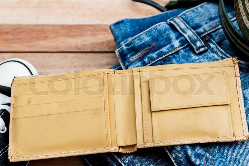 Vintage yellow wallet and accessories on a wooden background, stock photo