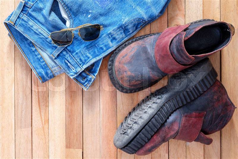 Jeans and Boots,Aviator sunglasses on top of wooden, stock photo