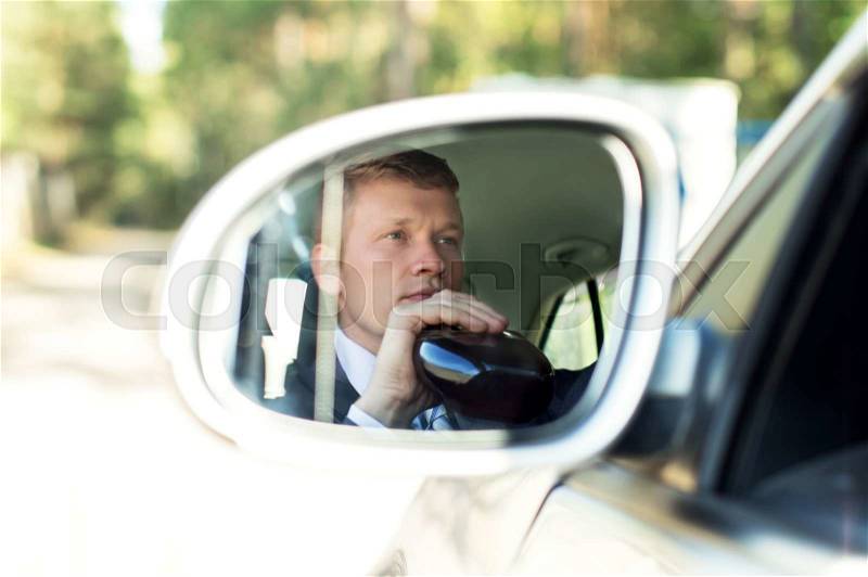 Man with alcohol behind the wheel of the car in the mirror, stock photo