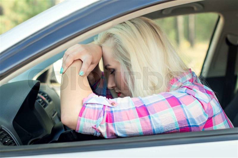 Driver was tired and fell asleep at the wheel of a car, stock photo