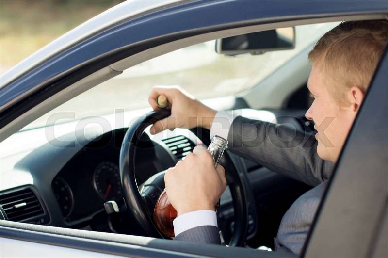Driver sitting behind the wheel of drinks, stock photo