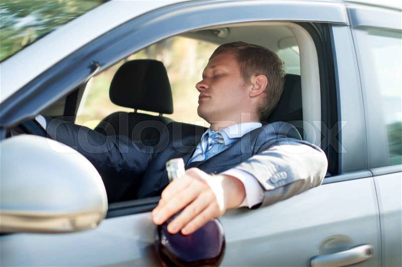 Drunk driver fell asleep at the wheel of the car, stock photo