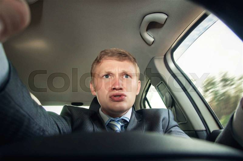 Aggression behind the wheel, the driver is surprised while driving, stock photo