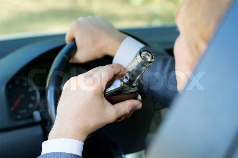 Driver controls the car in a drunken state, stock photo