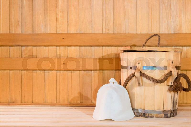 Wooden tub and a woolen cap, close-up in the sauna, stock photo