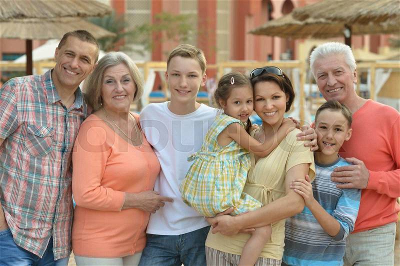 Portrait of a happy family relaxing at vacation resort, stock photo