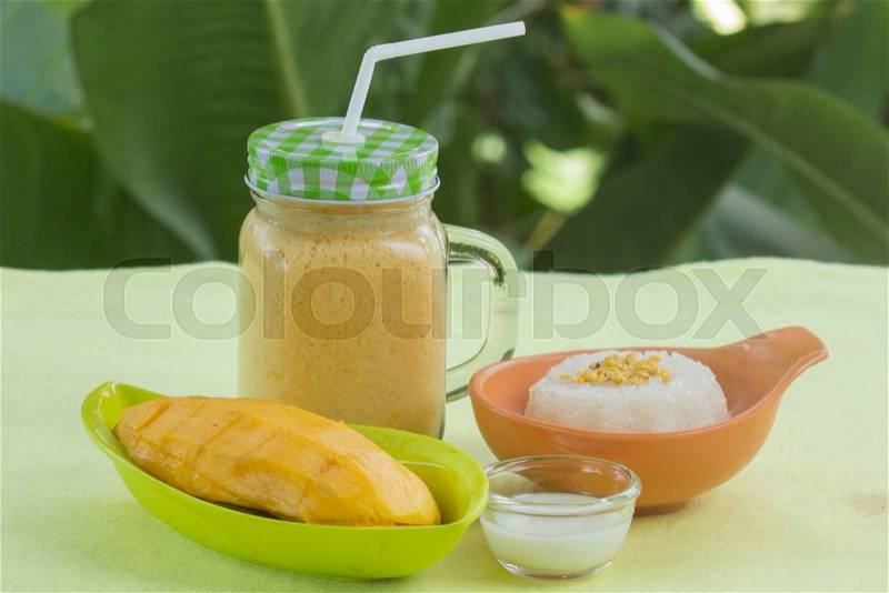 Sticky rice cooked with coconut milk and mango and smoothies /Thai style dessert, stock photo