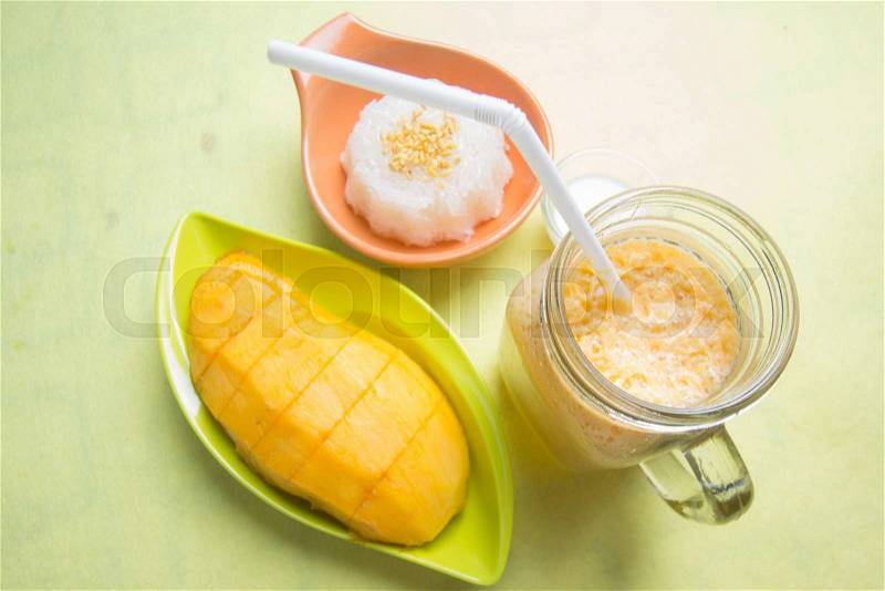 Sticky rice cooked with coconut milk and mango and smoothies /Thai style dessert, stock photo