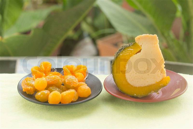 Half of Egg Custard in the pumpkin and egg yoke fudge balls cooked in syrup / Thai sweet desert, stock photo
