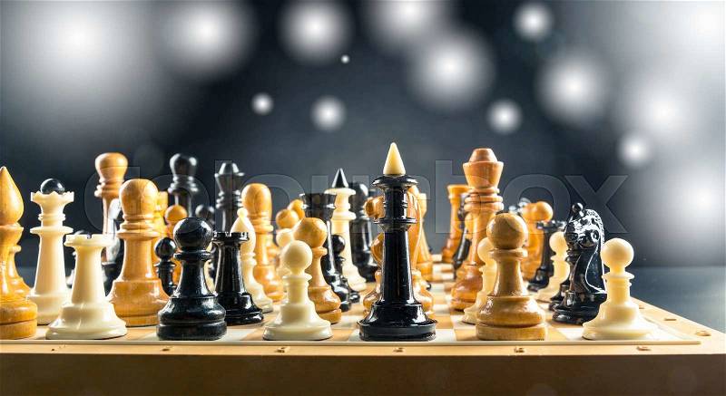 Many chess figures standing on the board, stock photo