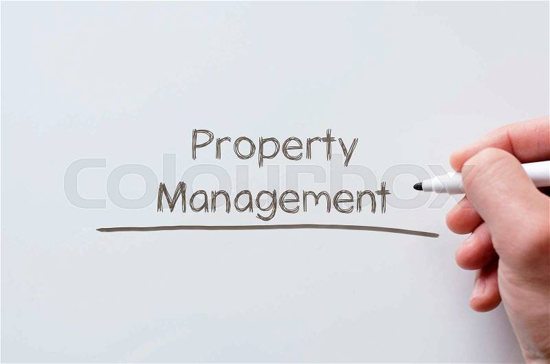 Human hand writing property management on whiteboard, stock photo