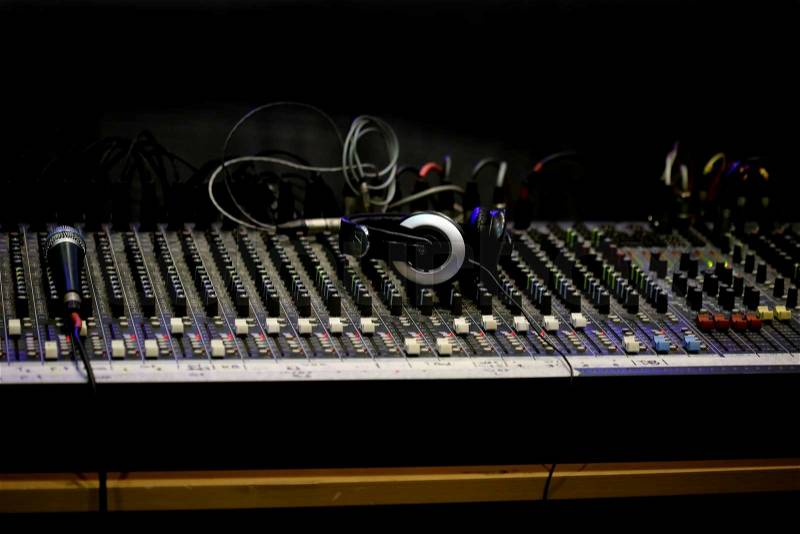 Sound mixer board and headphone in studio, stock photo