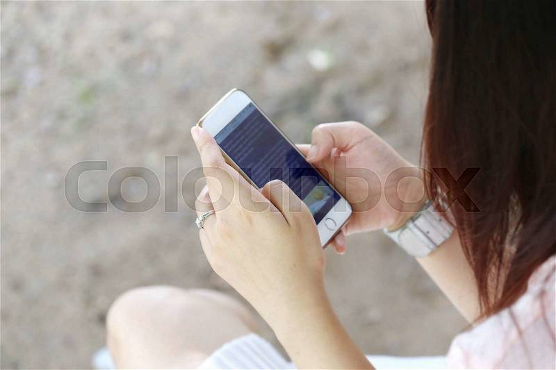 Young women hand hold smart phone, stock photo