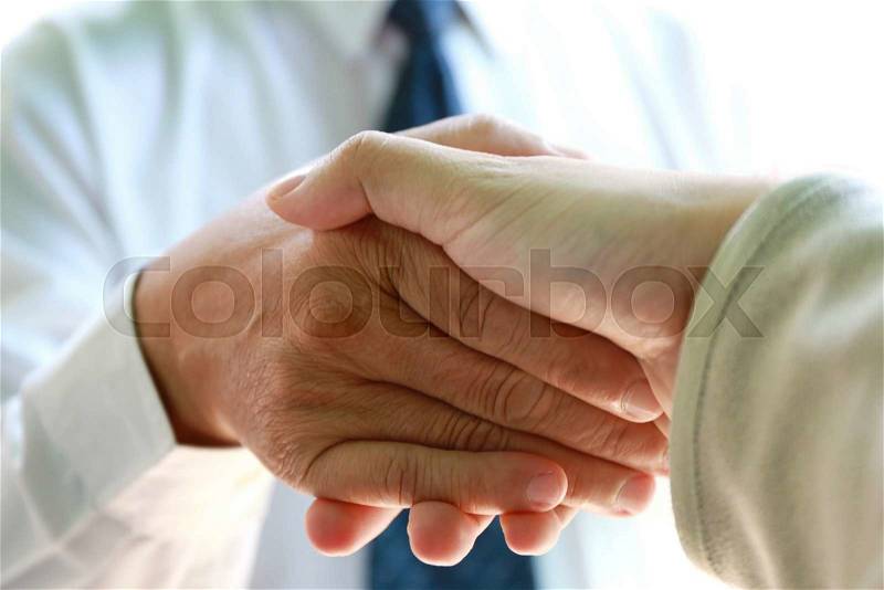 Businessman handshake with young man for start up new generation business, stock photo