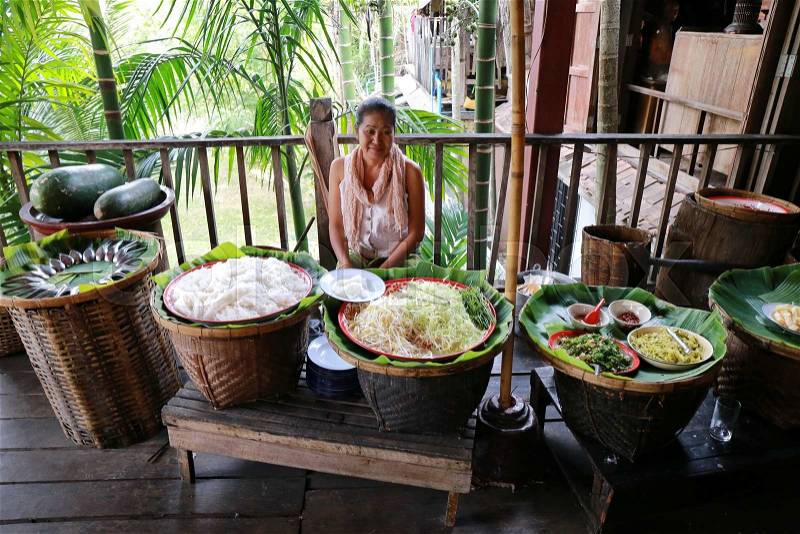 CHIANG MAI, THAILAND - FEB 13: A woman serves Thai food at ancient market on February 13, 2015 in Chiang Mai, Thailand. Its popular for traditional style food and old Thai culture, stock photo