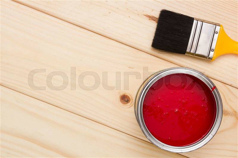 Brush for paint and paint on a wooden background, stock photo