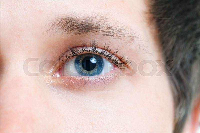 Close-up picture of blue eyes from a young man, stock photo