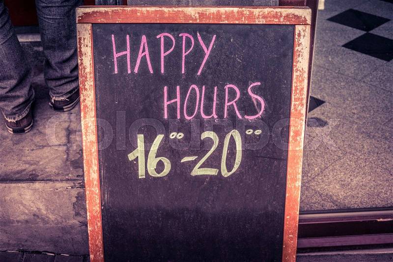 Happy hour board with text written in chalk, stock photo